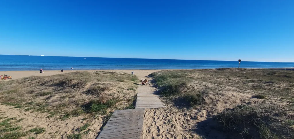 Wooden boardwalk leading to the Mediterranean beach in Alicante, Spain