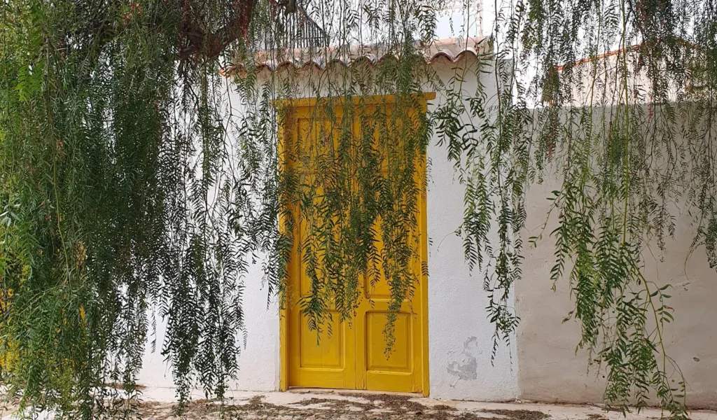 Yellow door on a white wall in Isla Tabarca, Alicante, Spain