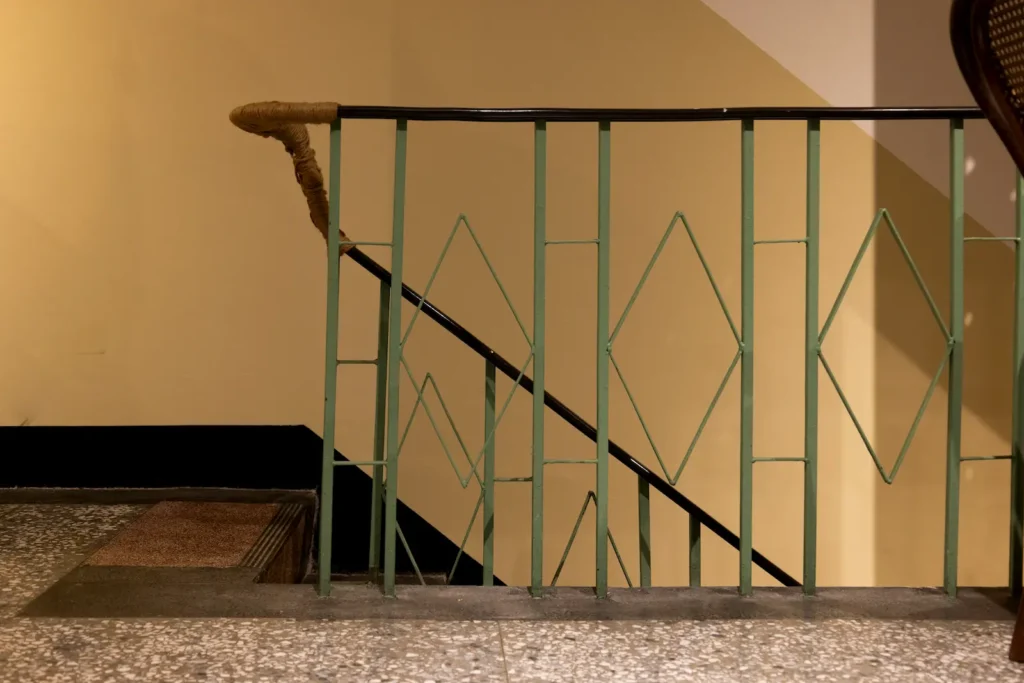 Terrazzo floor and green iron railings in a Spanish apartment building stairwell