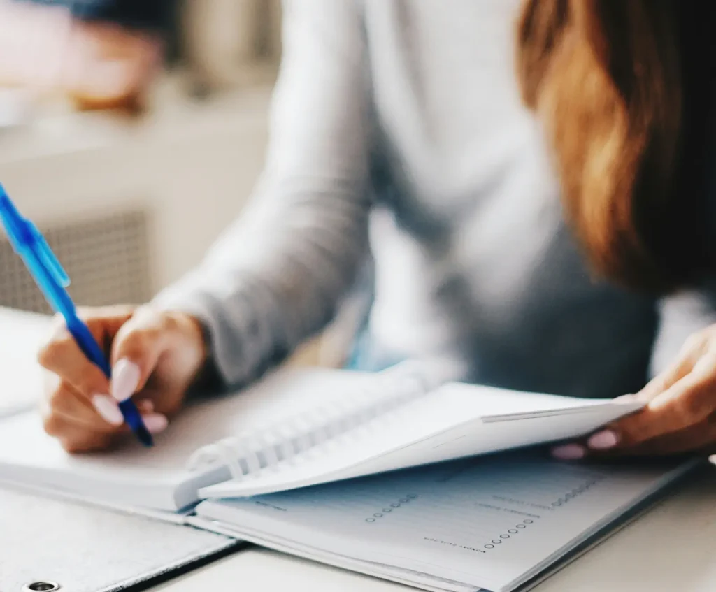 Person reviewing paperwork at a desk