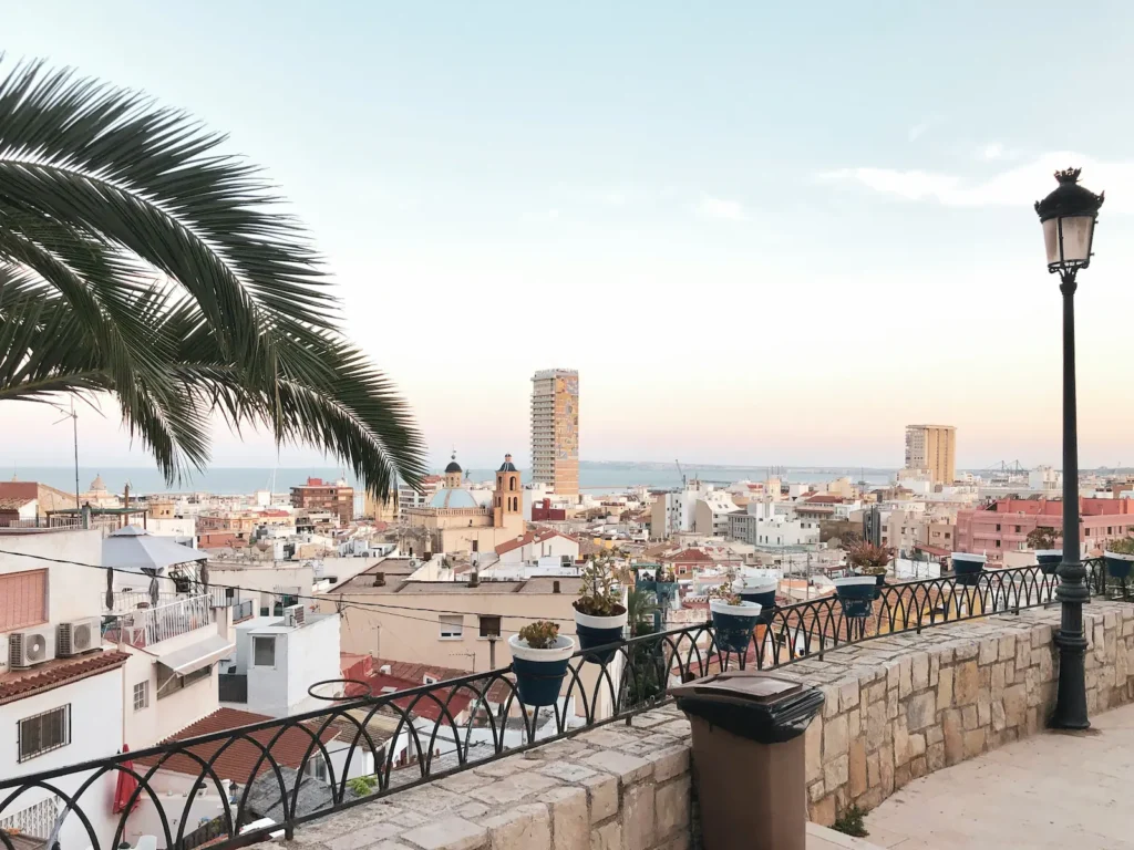 Alicante city skyline viewed from Santa Bárbara castle with rooftops and Mediterranean sea